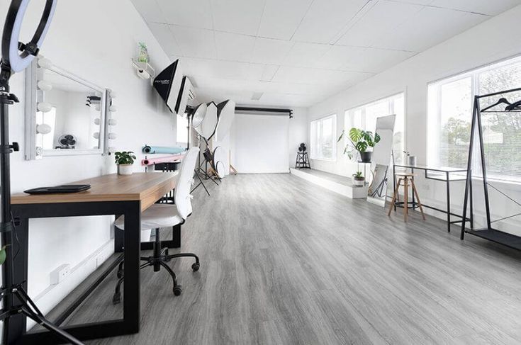 an office with white walls and wood floors