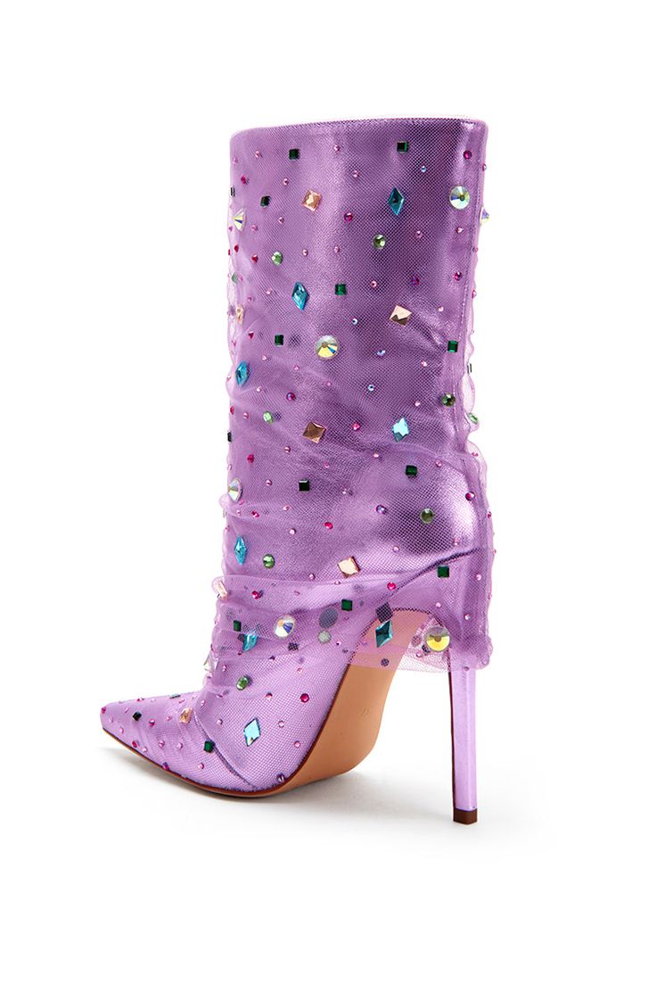 **FINAL SALE - NO EXCHANGES OR RETURNS** All the glam and luxury you would ever want out of a heeled boot! The Liora Stiletto Boot in Lilac Purple features a metallic, shiny base with a pointed toe silhouette. There is a tulle overlay on the boot and multicolored chunky rhinestones scattered all over the shoe. These are perfect for adding a pop of color to any elevated outfit! Trendy High-top Mid-calf Party Boots, Trendy High-top Mid-calf Boots For Party, Glamorous High Ankle Boots For Party, High-top Party Boots For Spring, Spring Party High-top Boots, Trendy Mid-calf Boots With Reinforced Heel For Party, Glamorous Boots With Round Toe For Party Season, Glamorous Round Toe Boots For Party Season, Glamorous Round Toe Boots For Parties