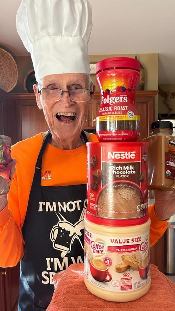 an older woman is standing in the kitchen with some food on top of her head