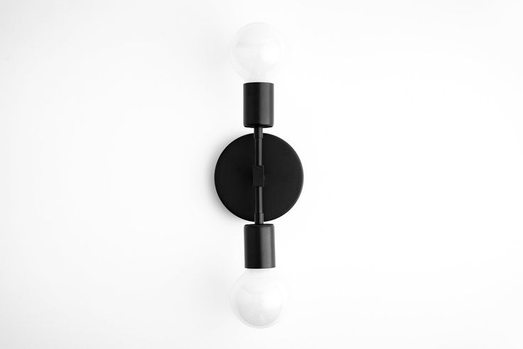 a black and white wall light with two bulbs on it