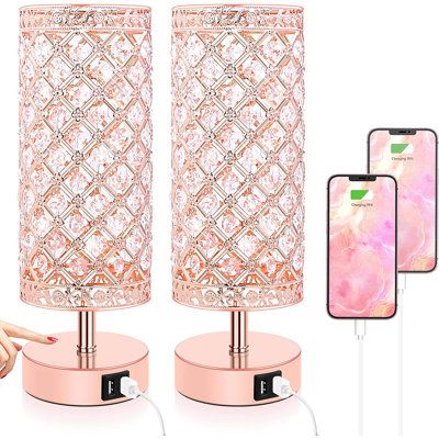 the pink lamp is next to two cell phones