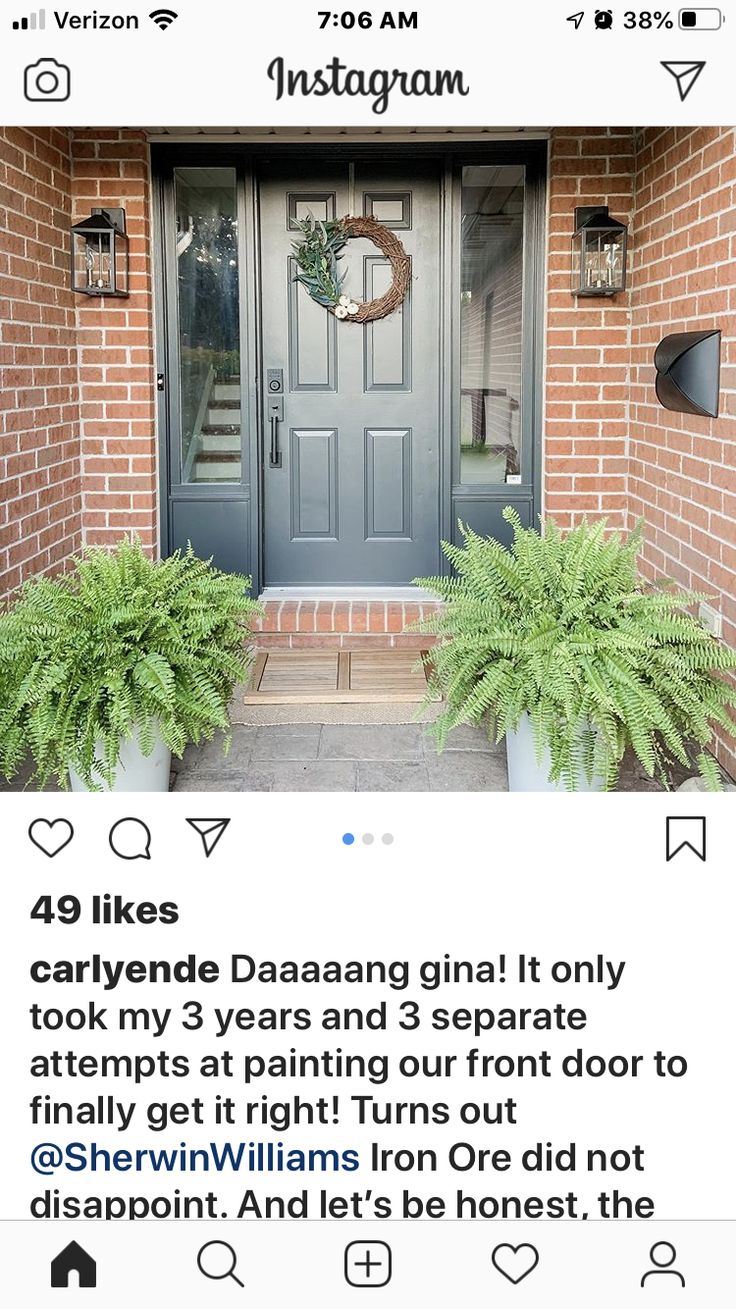 an instagramted photo of a front door with plants and wreaths on it