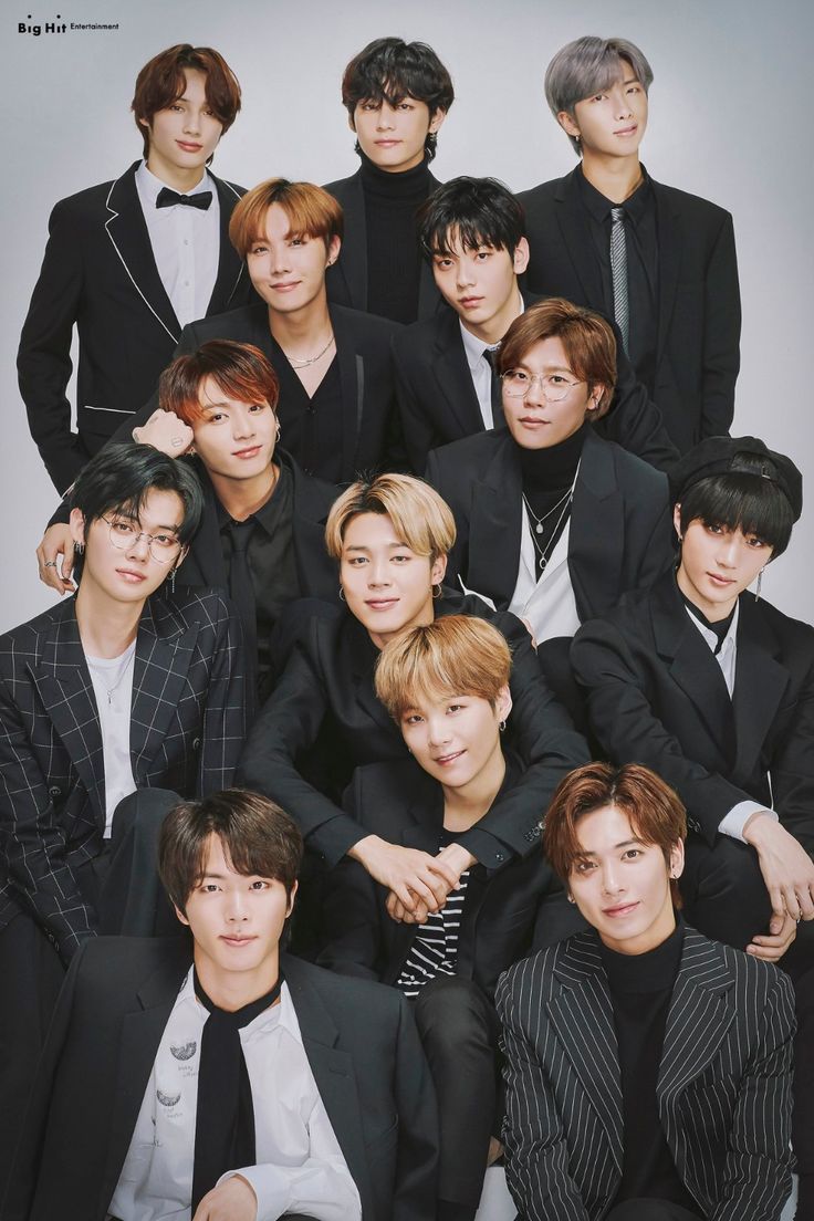 the group of young men are posing together for a photo in black suits and ties