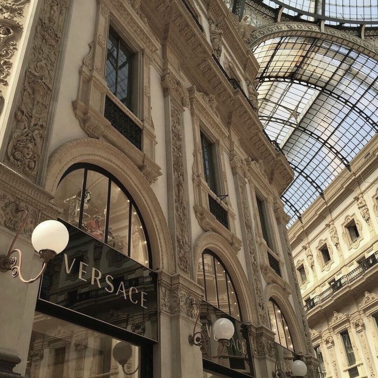 an ornate building with glass roof and windows