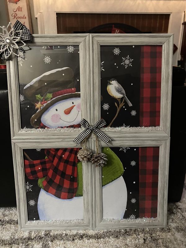 an old window decorated with snowmen and plaid