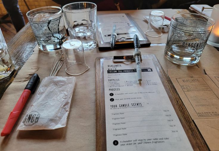 a table with glasses and menus on it