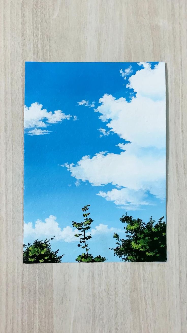 the sky is blue and white with some clouds in it, as well as trees