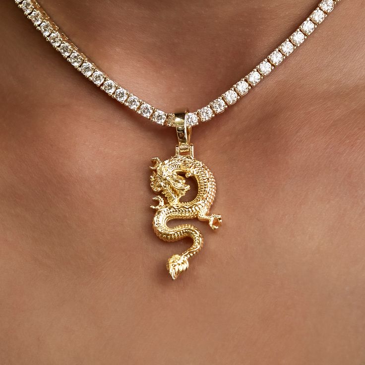 Introducing the Dragon Pendant in 18k Yellow Gold. The dragon is a symbol of power, strength, and good luck for those worthy. Carefully crafted with the utmost attention to detail, we bring this mythical creature to life with this intricate piece. Pair it with a Diamond Tennis Necklace for added shine! This product is guaranteed for life - GLD will repair the item should you experience any defects in craftsmanship or breakage. Specifications - 17mm x 33mm (Width x Height) - Bail: Fits up to 6mm Traditional Gold Jewelry With Dragon Design, Symbolic Gold Dragon Jewelry, Spiritual Gold Jewelry With Dragon Design, Symbolic Gold Jewelry With Dragon Design, Luxury Gold Dragon Design Jewelry, Luxury Gold Jewelry With Dragon Design, Gold Dragon Design Jewelry, Yellow Gold Dragon Design Jewelry Gift, Gold Jewelry With Dragon Design