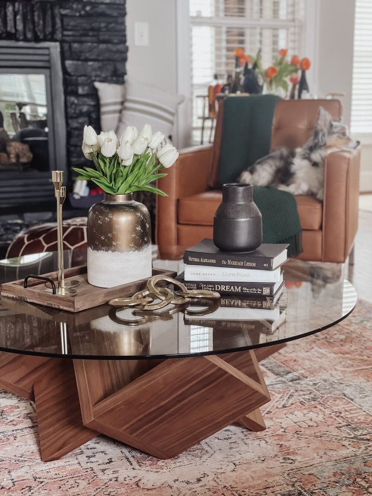 a glass table topped with books and flowers