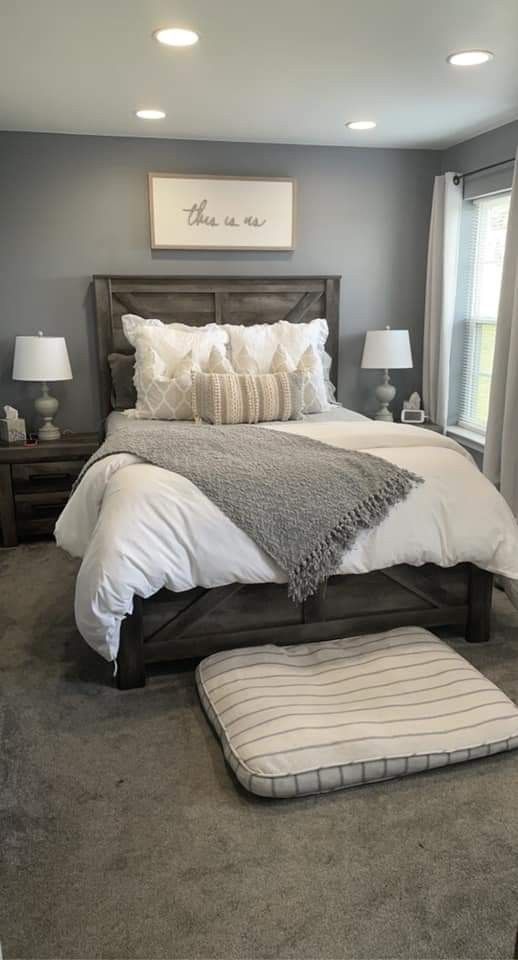 a large bed sitting in a bedroom on top of a carpeted floor next to two lamps