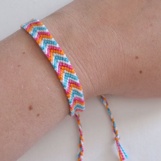 a person wearing a colorful bracelet on their arm