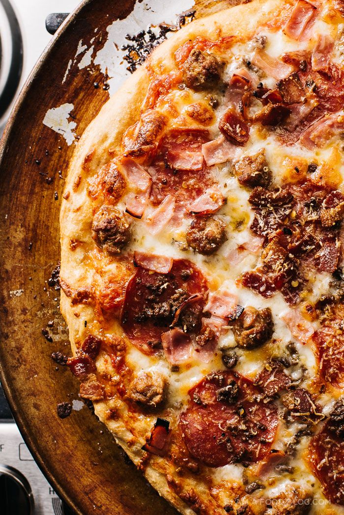 a pizza sitting on top of a pan covered in cheese