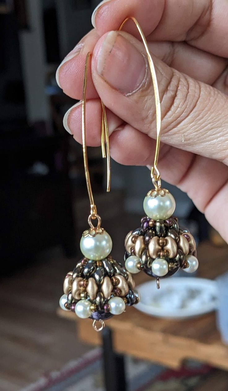 These are Indian style jewelries called Jhumka. Every single piece is handmade by me using high quality product such as beads from Miyuki, some hoops are 14 to 18 carat gold plated (the ones studded with zirconia diamond crystals), crystals are mainly from Czech from Periciosa. The  green bicone crystal Jhumka in this listing and the bronze pearl inside the bronze Jhumka are all Swarovski products. I buy the Swarovski gems from a major wholesalers here in Vancouver BC. Please note the hoop style Gold Earrings With Spacer And Round Beads, Festive Drop Earrings With Gold Beads, Elegant Gold Beaded Earrings With Spacer Beads, Fusion Gold Beaded Jewelry, Fusion Style Gold Beaded Jewelry, Gold Beaded Round Earrings As Gift, Round Gold Beads Earrings For Gift, Handmade Fusion Dangle Jhumkas, Handmade Fusion Style Dangle Jhumkas