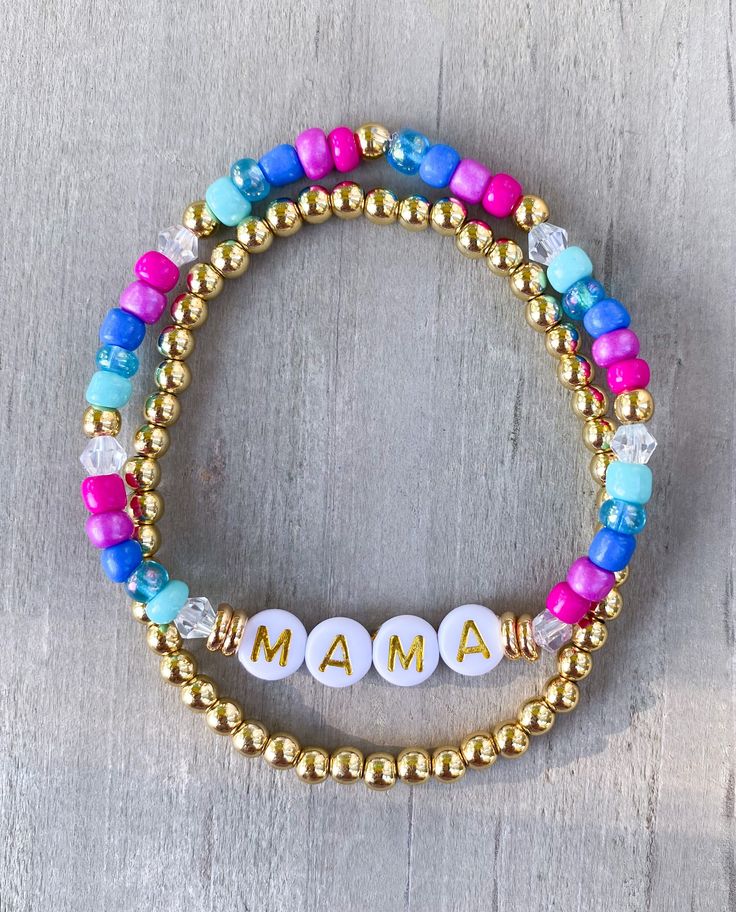 "Mama Bracelet 🤍 Simple, chic Mama bracelet Made with 4mm colored seed beads, 18k gold filled accents and 6mm gold circle letters that read \"Mama\" Gold bracelet made with 18k gold filled beads If you would like another word or color, please put in Personalization Section* and we will contact you if we have questions.  CARING TIPS FOR YOUR JEWELRY ⭐️Treat and store with care. ⭐️ For longevity, avoid exposing your jewelry to water. ⭐️ Avoid having direct contact with lotions, perfumes, sanitizers as these chemicals may cause discoloration of your jewelry." Colorful Bracelets With Spacer Beads For Gifts, Colorful Bracelets With Spacer Beads As Gift, Adjustable Multicolor Beaded Bracelets For Birthday, Gold Friendship Bracelets With Colorful Beads For Birthday, Birthday Gold Friendship Bracelets With Colorful Beads, Multicolor Beaded Friendship Bracelets For Mother's Day, Personalized Multicolor Round Bead Friendship Bracelets, Multicolor Friendship Bracelets For Mother's Day, Colorful Adjustable Beaded Bracelets With Letter Beads