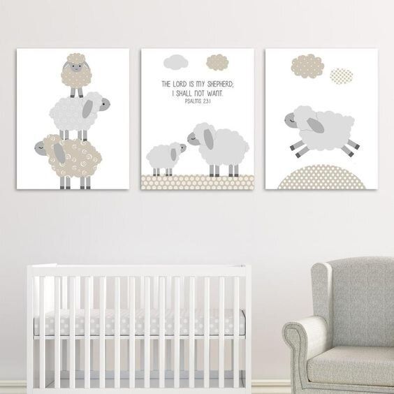 three sheep are hanging on the wall next to a baby's nursery crib