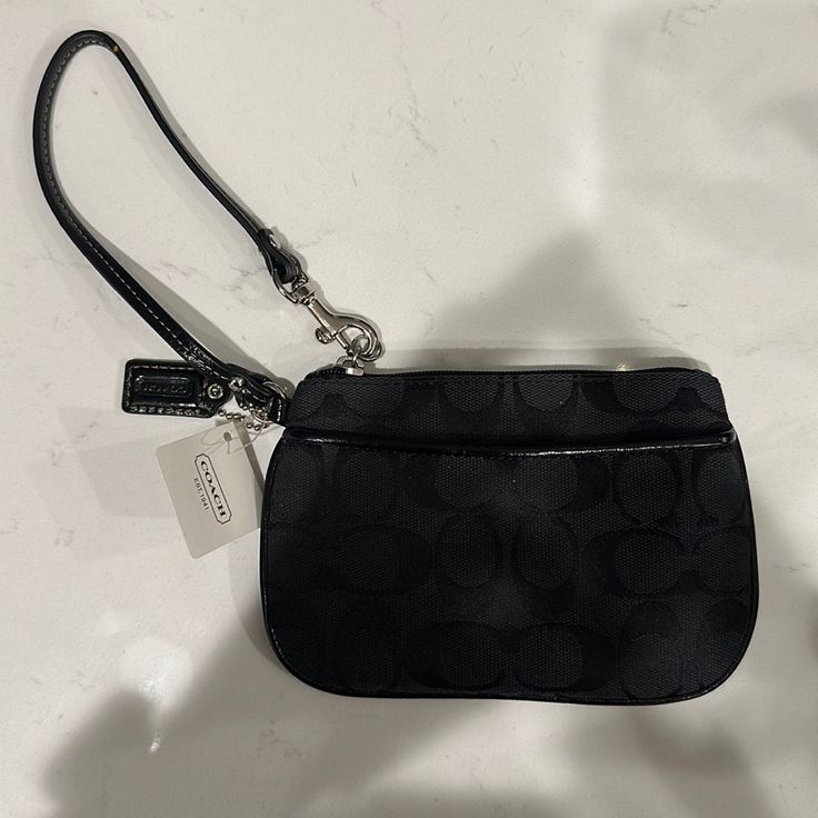 Coach Signature Small Wristlet. Brand New, Never Worn With Tags. Sv/Black Grey/Black. Mostly Just Black With A Grey Interior. Make An Offer. Black Handheld Clutch With Zipper Closure, Black Travel Bag With Wrist Strap, Black Clutch Wallet With Wrist Strap, Black Wallets With Wrist Strap For Evening, Black Rectangular Wristlet With Zipper Closure, Black Clutch With Wrist Strap For Daily Use, Black Evening Wallet With Wrist Strap, Black Zipper Pouch Wristlet For Travel, Black Pouch Wristlet With Zipper Closure