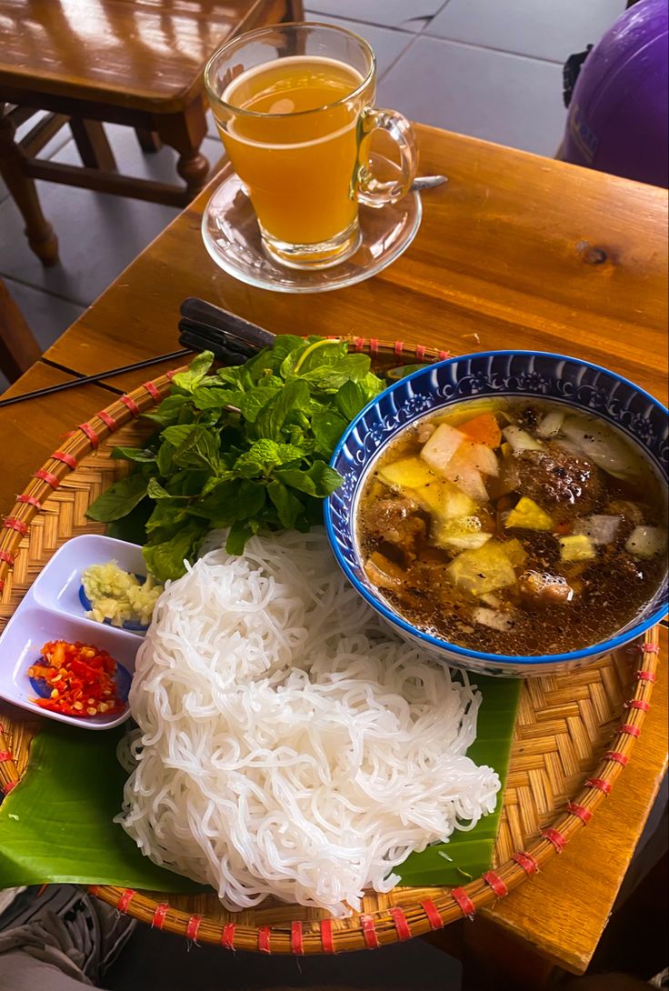 there is a bowl of soup and rice on the table