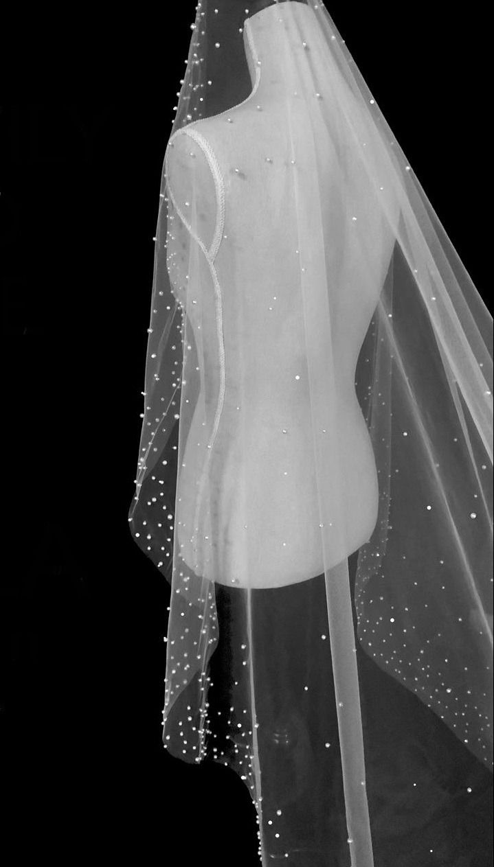 a wedding veil is hanging on a mannequin