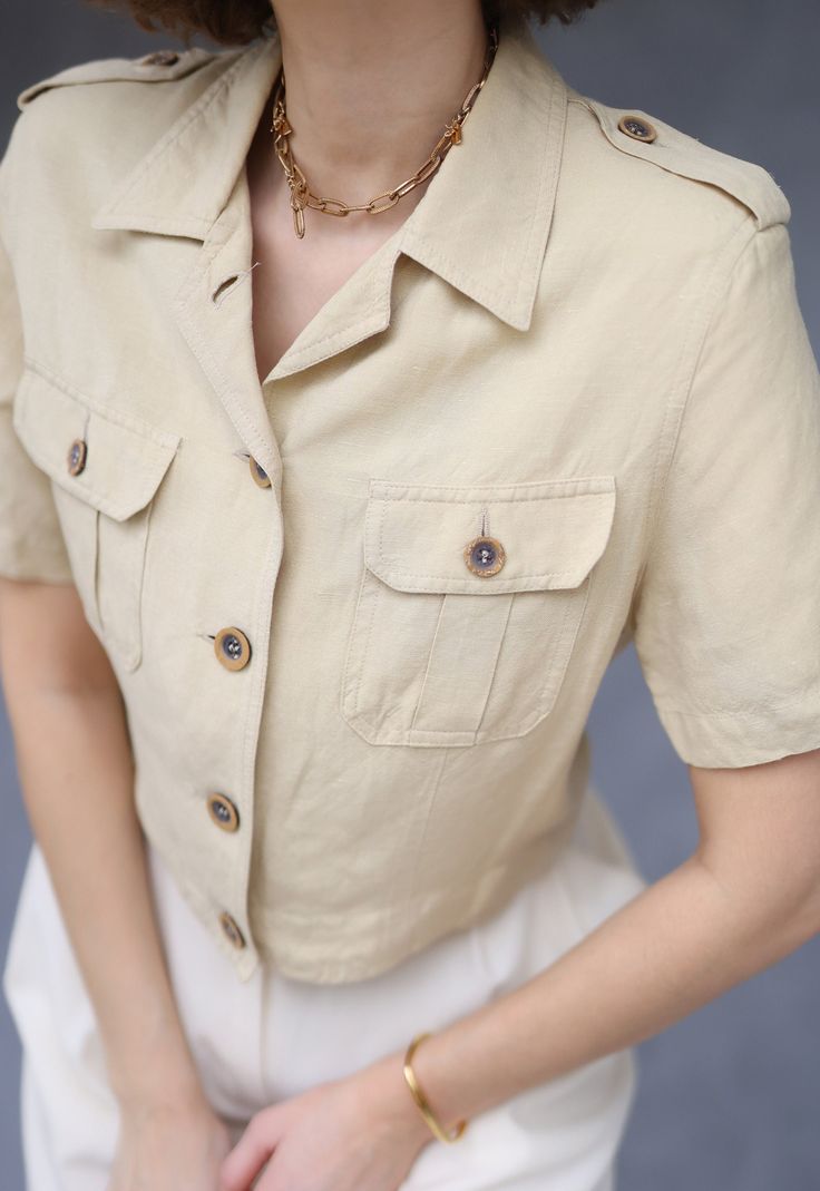 Vintage beige linen short sleeve jacket blouse top. Front button closure, lightly padded shoulders (can be removed), shoulder lining. Material is 50% linen 50% viscose. Tag: PTA Size 38 / US 10 / UK 12 Fits like size S-M Measured laying flat (double for circumference): 17" / 43 cm long 20'' / 51 cm bust armpit to armpit 17.5" / 45 cm waist 16'' / 41 cm shoulders seam to seam 8.5" / 21 cm sleeve length Great vintage condition. Elegant Beige Single Breasted Top, Elegant Beige Single-breasted Top, Neutral Short Sleeve Blouse For Workwear, Neutral Short Sleeve Blouse For Work, Khaki Summer Office Tops, Khaki Office Tops For Summer, Beige Collared Single-breasted Top, Chic Beige Single Breasted Top, Chic Beige Single-breasted Top