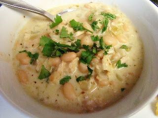 a white bowl filled with soup and garnished with cilantro