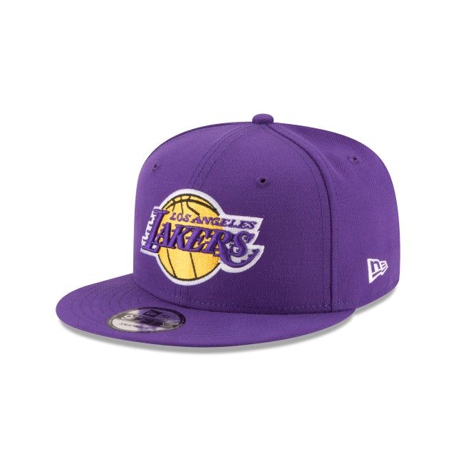 The Los Angeles Lakers 9FIFTY Snapback features an allover team colored fabrication with an embroidered Lakers logo at the front panels and an embroidered NBA logo at the rear above an adjustable snapback closure. Snapback Hat With Team Logo For Fans, Casual Team-colored Snapback Hat With Flat Brim, Casual Team-colored Flat Brim Snapback Hat, Flat Bill Snapback Hat With Team Logo, Purple Snapback Cap For Streetwear, Purple Snapback Hat For Streetwear, Casual Purple Baseball Cap For Streetwear, Casual Purple Snapback Hat For Streetwear, Adjustable Purple Baseball Cap For Sports