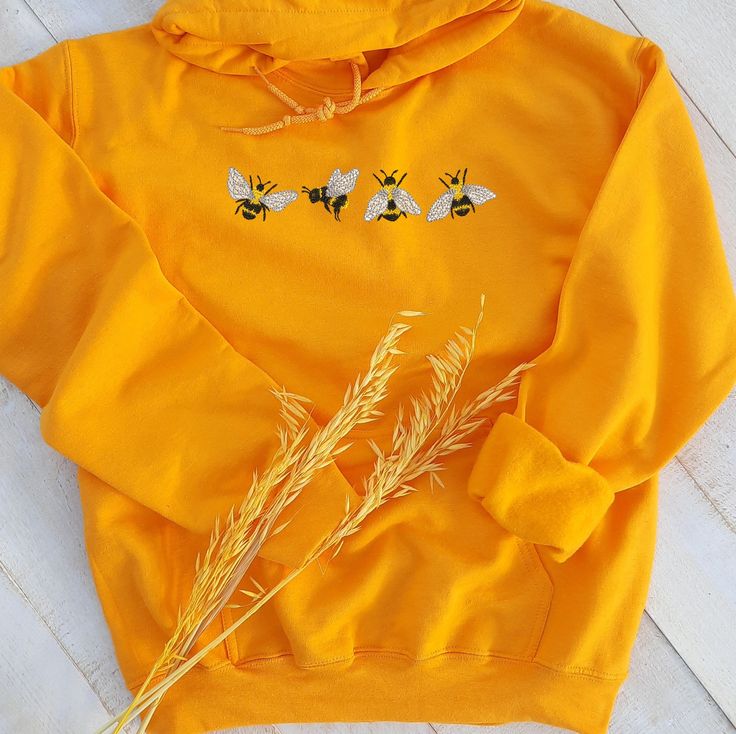 Really soft and comfortable embroidered unisex hooded sweatshirt with a cute bees embroidered on it made of high quality! Each hoodie is made in the size and color of your choice, with a unique design. I suggest you use your usual size for a better fit or choose a size for a looser fit.   Hoodies in unisex style with unique design the perfect gift for your best friend, loved one or your new favorite crewneck hooded sweatshirt for autumn, winter, spring and even cool summer!  Production. They are Cute Cotton Hoodie With Custom Embroidery, Cute Hooded Sweatshirt With Custom Embroidery, Cute Embroidered Long Sleeve Hoodie, Cute Hooded Sweatshirt With Embroidered Graphics, Cute Hoodie With Custom Embroidery For Winter, Cute Winter Hoodie With Custom Embroidery, Embroidered Fleece Hoodie, Cute Embroidered Graphics Hoodie For Winter, Cute Hooded Hoodie With Embroidered Logo