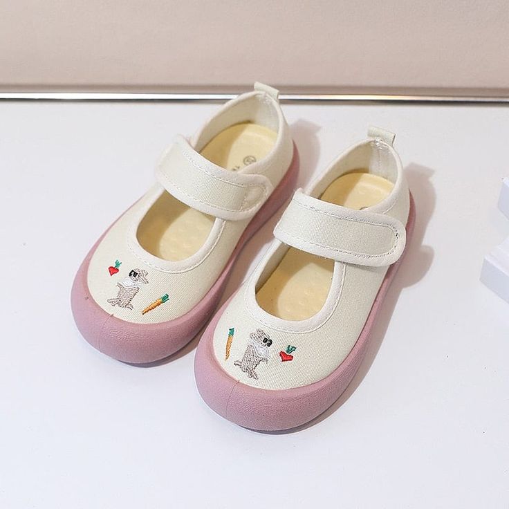 These adorable Mary Jane shoes feature an adorable cartoon design with a touch fastener strap. They offer arch support and have a soft heel insole for added comfort. Upper Material: CanvasOutsole Material: RubberLining Material: CanvasInsole Material: PU Suggested Age US Size EU Size FootLength Inch cm 2T 6 22 5.5 13.9 2T 7 23 5.7 14.4 2.5T 8 24 5.9 14.9 3T 9 25 6.1 15.4 3.5T 9.5 26 6.3 15.9 4T 10 27 6.5 16.4 5T 11 28 6.6 16.9 5T 11.5 29 6.8 17.4 5.5T 12.5 30 7 17.9 6T 13 31 7.2 18.4 6.5T 1 32 7 Cartoon Sneakers With Rubber Sole And Round Toe, Cartoon Print Sneakers With Round Toe, Casual White Slip-on Mary Janes, Cute Mary Janes With Rubber Sole And Round Toe, Playful Non-slip Closed Toe Sneakers, Casual White Mary Janes With Round Toe, White Non-slip Canvas Shoes With Round Toe, Non-slip Round Toe Fun Sneakers, Fun Cartoon Print Sneakers With Round Toe