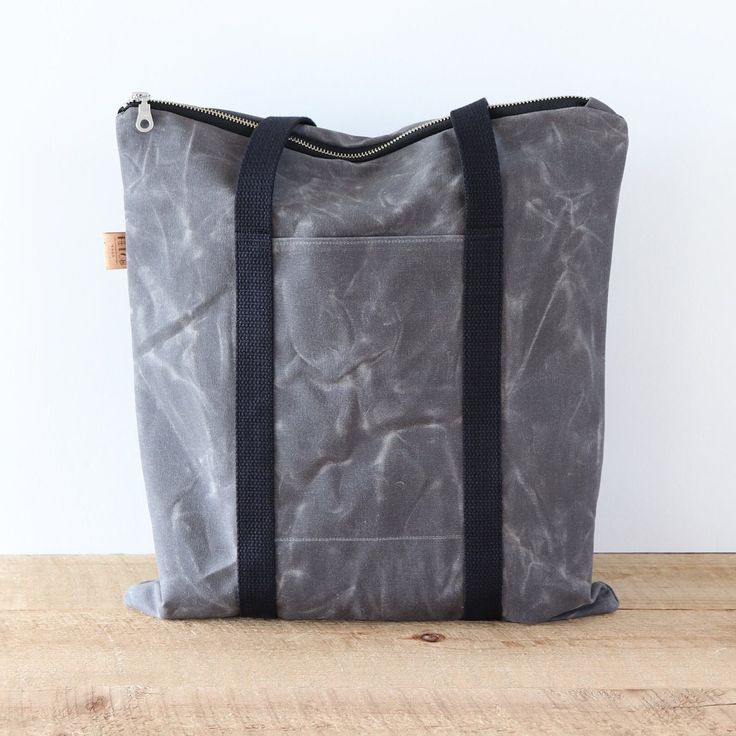 "This waxed canvas tote bag will hold a 13 inch laptop and a bunch more. Like all my bags, it is vegan. There's an exterior pocket that will fit your phone, and 3 interior slip pockets for all your essentials. The exterior is made of 13 oz waxed cotton canvas.  Waxed Canvas acts as a natural water repellent, so you'll love having it by your side rain or shine.  Waxed canvas has a worn and rustic appearance and texture.  It is normal for it to look like it has scratches and creases.  Bag Details ▪️Bag measures  15.5 (H) x 14 (W), lays flat ▪️Tote handles are 25 inches long ▪️Lined with black cotton twill fabric ▪️Interior triple slip pockets ▪️YKK top zipper closure ▪️Choose antique brass or silver hardware  ▪️Double stitched outer seams  ▪️Black cotton webbing tote handles  ▪️Easily fits a Functional Everyday Waxed Canvas Bag, Functional Waxed Canvas Bag With Zipper, Functional Waxed Canvas Bags With Zipper, Outdoor Canvas Tote Bag With Zipper Closure, Duck Canvas Bag With Zipper Pocket For Everyday Use, Everyday Duck Canvas Bag With Zipper Pocket, Waxed Canvas Bag With Zipper Pocket For Daily Use, Everyday Waxed Canvas Bag With Zipper Pocket, Practical Everyday Waxed Canvas Bag