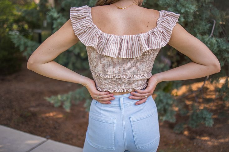 Get ready to look effortlessly chic in our Cropped Striped Top! This tan and striped top features a cropped length and ruffle sleeves, perfect for pairing with your favorite high-waisted bottoms. The smocked bodice adds a touch of fun and flirty to your look. Stay on trend with this versatile and stylish top! -Fits true to size, size up for added length -100% cotton Chic Smocked Crop Top For Brunch, Cropped Smocked Top For Brunch, Chic Crop Top With Smocked Bodice For Vacation, Chic Smocked Crop Top For Summer, Chic Ruffled Crop Top For Vacation, Chic Smocked Bodice Crop Top For Vacation, Chic Smocked Bodice Crop Top For Brunch, Chic Cotton Crop Top With Smocked Bodice, Cropped Smocked Top With Ruffles For Brunch