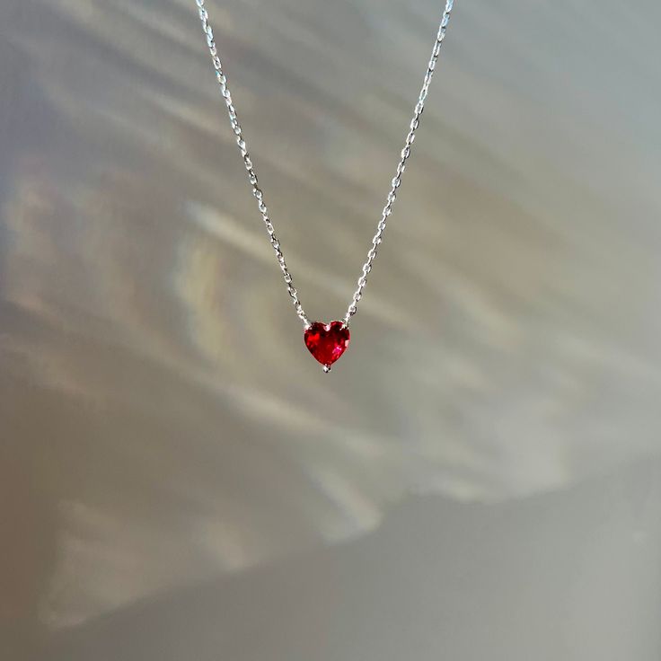 Red crystal heart necklace pendant made in solid 925 sterling silver and rhodium coated. Embellished with red cubic zirconia. Chain length: Adjustable 18, 16 inches Pendant size: approx. 0.6 cm  It comes with a little velvet pouch ready to be gifted! Red Sterling Silver Heart Pendant Jewelry, Red Heart Cut Birthstone Necklace, Red Lab-created Ruby Necklace As Gift, Gift Red Lab-created Ruby Necklace, Red Lab-created Ruby Necklace For Gift, Red Lab-created Ruby Necklace Gift, Sterling Silver Red Heart Necklace, Red Cubic Zirconia Heart Pendant Jewelry, Red Sterling Silver Necklace With Heart Pendant