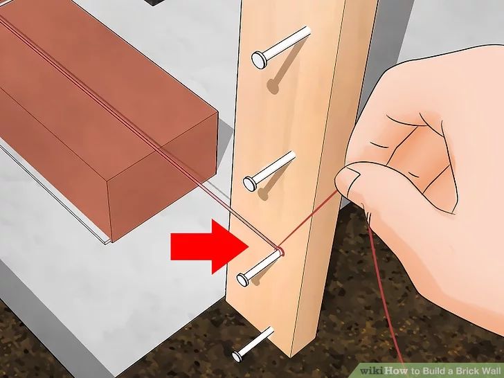 a person is opening a drawer with the door open and pointing at something on it