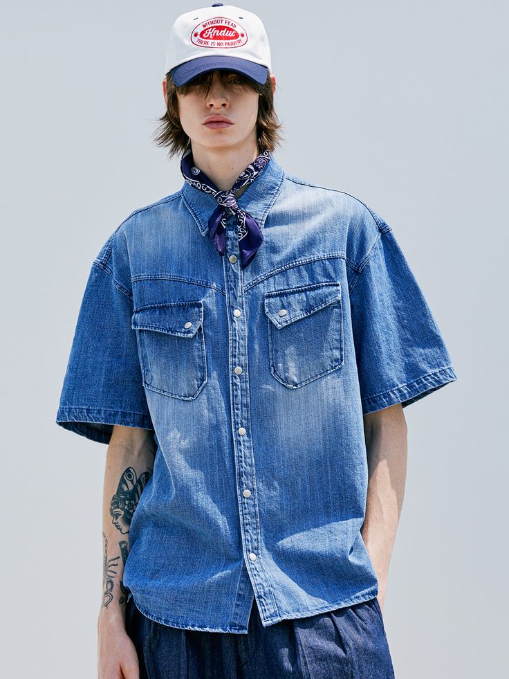 Editor's notesWashed Denim Western Shirt by KND is made of 100% cotton, providing a cool and lightweight feel. This shirt is a denim shirt with a curved-shaped yoke and slanted pocket details on the front. It features a relaxed loose fit. The fabric has undergone bleach and brush washing processes, giving it a more vintage look. The buttons used are snap buttons. It is a versatile shirt that can be styled with various outfits.- Relaxed loose fit- Two chest pockets- Slap button type- Versatile it Indigo Denim Shirt For Summer, Indigo Short Sleeve Cotton Denim Top, Indigo Short Sleeve Denim Top, Indigo Cotton Denim Top With Short Sleeves, Summer Indigo Denim Shirt, Dark Wash Summer Shirt With Pockets, Classic Cotton Denim Top For Summer, Classic Summer Denim Cotton Top, Distressed Collared Cotton Top