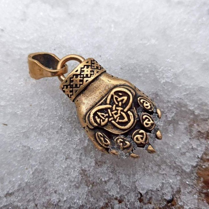 The bear paw pendant is a Slavic ethnic jewelry based on mythology and harmony with nature. As in Slavic Pagan culture bear was the personification of power, this animal was the king of the forest. The symbol depicted on the paw is called the "hall of the bear" or "bear chamber"denoting the position of the sun in the Slavic horoscope. You can add simple rubber cord for this pendant, bear necklace or bronze leather necklace. Pendant size: Height: 46 mm. | 1 4/5 inch Width: 20 mm. | 8/10 inch Weig Brass Claw Jewelry As Gift, Viking Style Handmade Gold Jewelry, Handmade Viking Gold Jewelry, Handmade Viking Style Gold Jewelry, Bronze Viking Jewelry For Ceremonial Occasions, Handmade Viking Style Bronze Jewelry, Viking Style Bronze Jewelry Gift, Pagan Culture, King Of The Forest