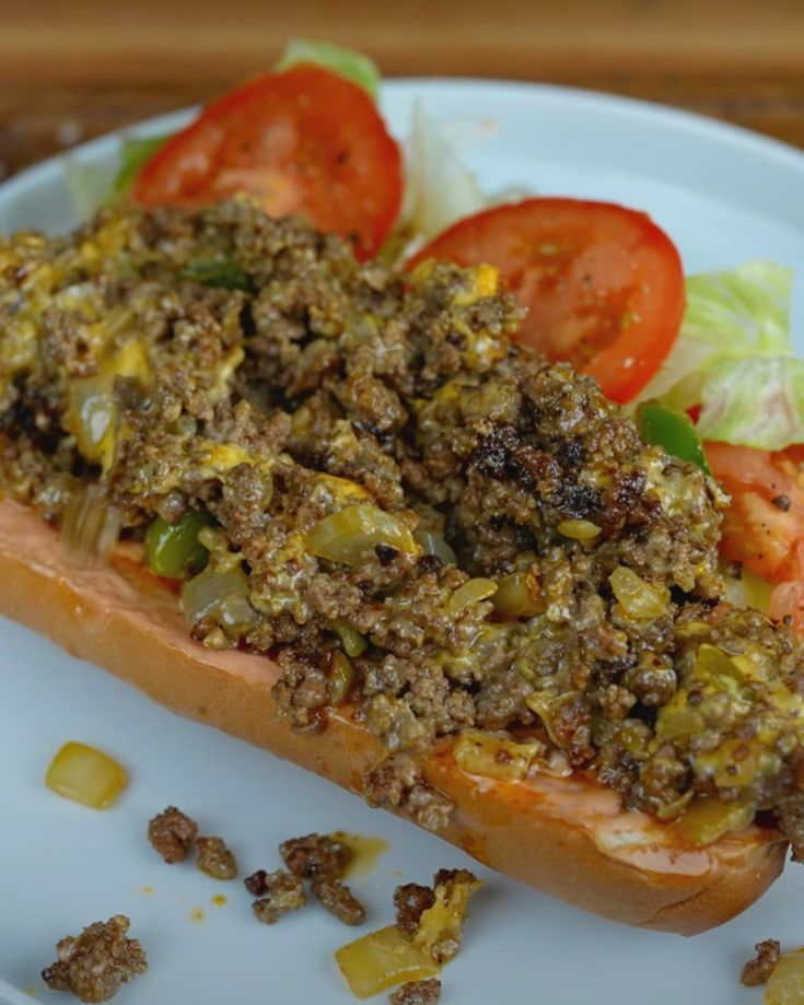 a sandwich on a plate with tomatoes and lettuce next to it's toppings