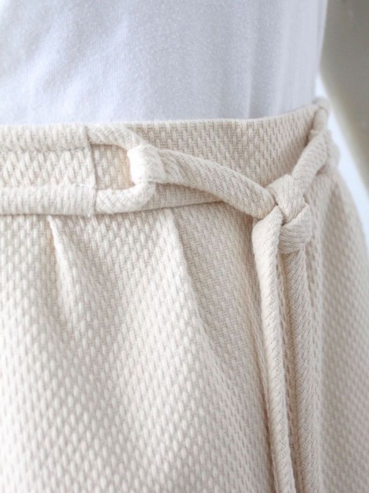 a close up of a person's pants with a tie around the waist