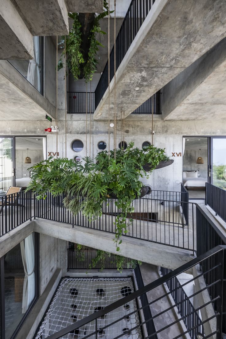 the interior of an apartment building with plants growing on the balconies and balcony railings