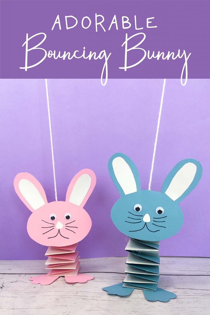 two paper bunnies with bunny ears hanging from the top, and an image of a rabbit