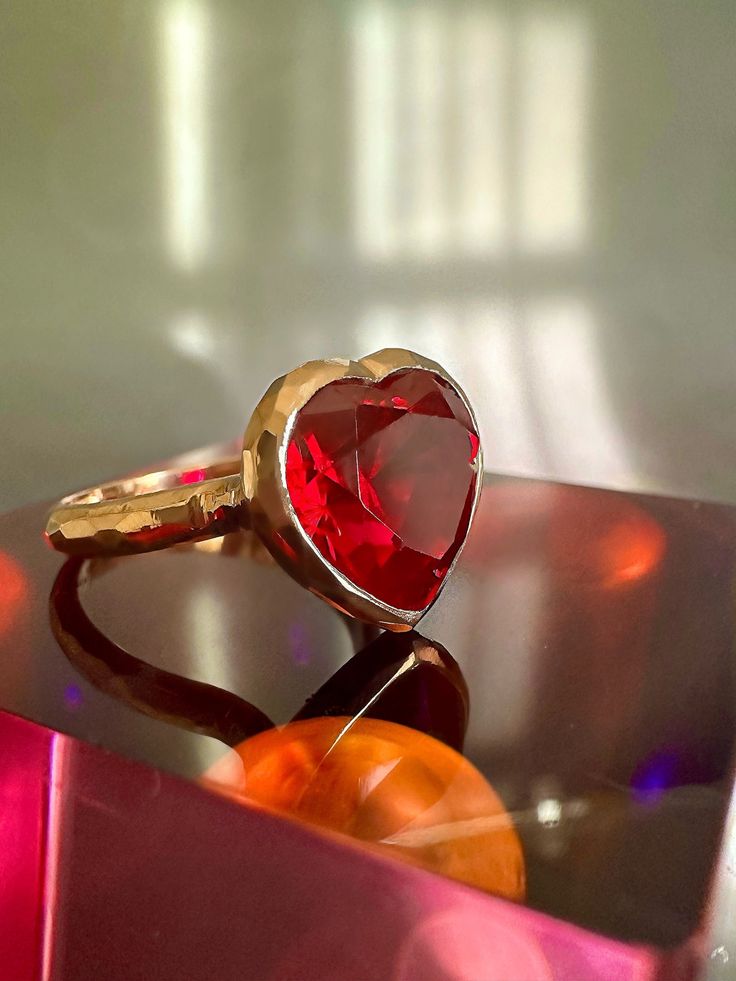 With its playful, symbolic vibe and juicy red color, this striking ring from our Simplicity Collection is a perfect addition to any modern collection. Large red heart shaped ruby is encased in meticulously hand finished band. This stunning ring will make a fun alternative to a traditional cocktail ring. Available for immediate shipping: Ruby 11mm x 12mm Set in 9K rose gold Size: 17.5 Please contact us for sizing options Red 14k Gold Heart Ring For Promise, Red 14k Gold Heart Promise Ring, 14k Gold Red Heart Ring For Promise, 14k Gold Heart Cut Red Heart Ring, 14k Gold Red Heart Cut Ring, 14k Gold Ruby Ring For Valentine's Day Gift, Valentine's Day 14k Gold Ruby Ring Fine Jewelry, Valentine's Day Gift Ruby Ring In 14k Gold, Valentine's Day 14k Gold Fine Ruby Ring