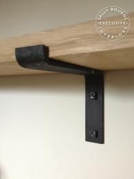 a wooden shelf with metal brackets on it