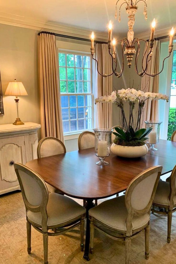 a dining room table with six chairs and a chandelier