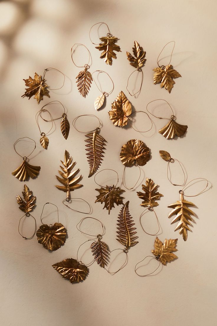 a group of gold leaf ornaments hanging on a wall