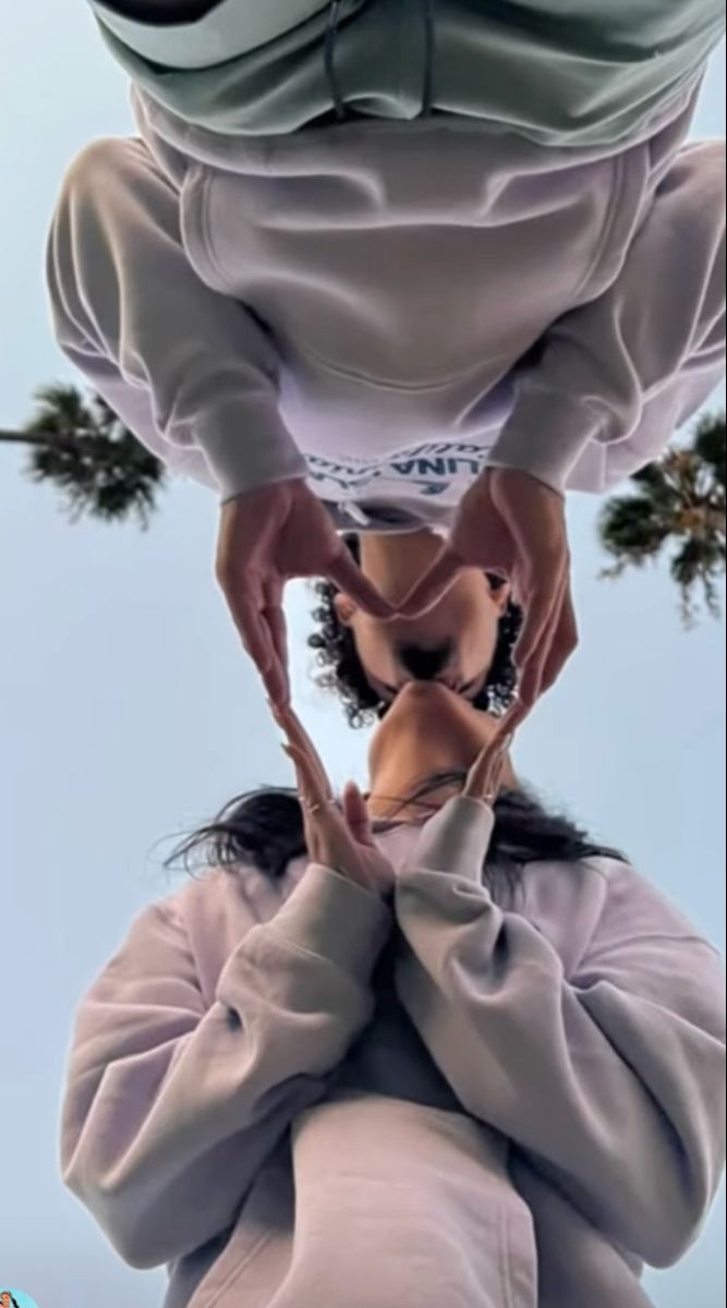 a woman is upside down in the middle of her body, with trees in the background