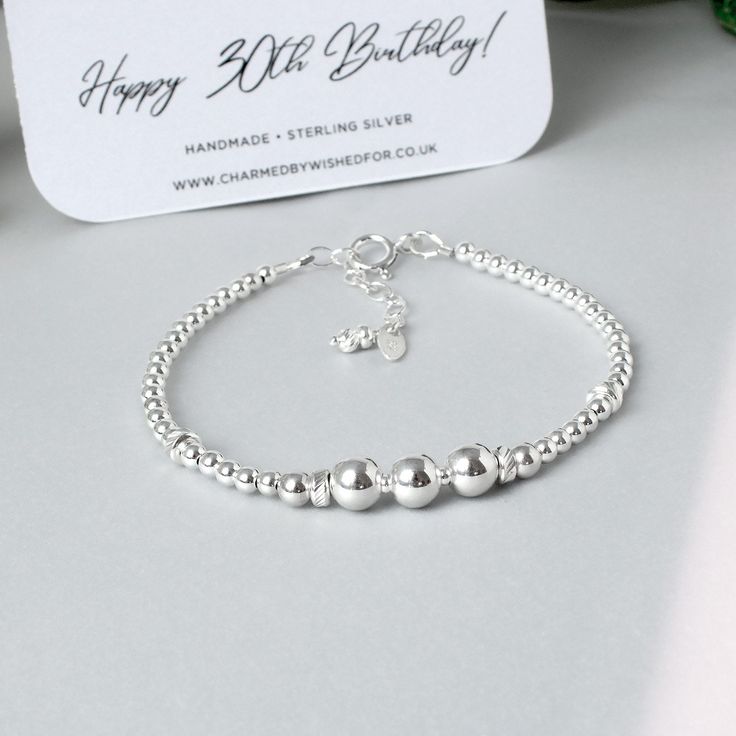 "Sterling silver bead bracelet for a 30th birthday. This lovely handmade bracelet is designed to celebrate a 30th birthday with 3 large shiny beads representing 3 decades. Made from all solid sterling silver, it's a really lovely & discreet way to mark this special birthday. Sterling bead bracelets look gorgeous worn singly or as part of a stack - either way the classic look of shiny silver is easy to wear and goes with anything. The bracelet has an extender chain making it adjustable between 6. Sterling Silver Bracelet With Round Beads For Anniversary, Elegant Silver Beaded Bracelets For Birthday Gift, Silver Round Beads Jewelry For Birthday, Sterling Silver Bracelet With Spacer Beads For Gift, Anniversary Sterling Silver Beaded Bracelets, Anniversary Silver Beaded Bracelets, Silver Sterling Beaded Bracelets For Birthday, Sterling Silver Beaded Bracelet For Anniversary, Silver Round Name Bracelet For Birthday