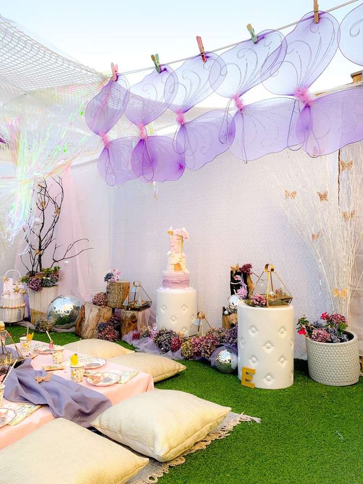 a table with cake and decorations on it in a room filled with green carpeted flooring