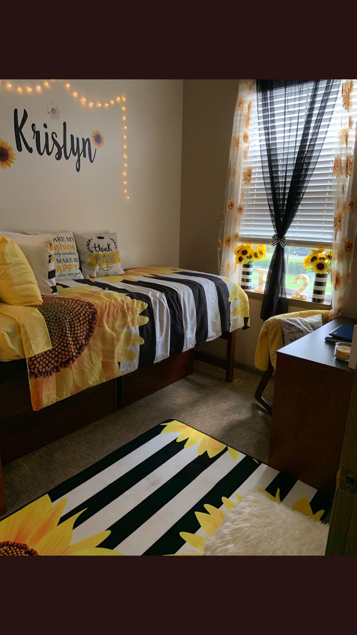 a bedroom with sunflowers and black and white decor on the walls, carpeted floor