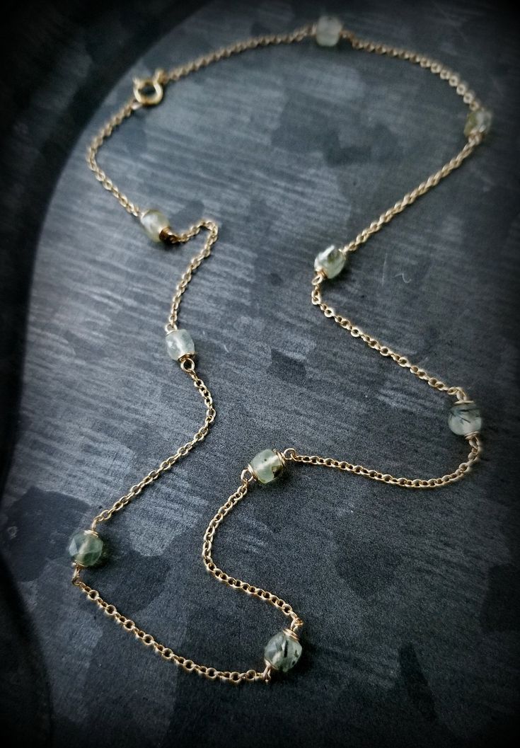 "Prehnite Lichen Necklace, 14k Gold Prehnite Station Necklace, Green and Gold Spring Necklace, 14k Gold Prehnite Layering Necklace, 16\" Lichen Necklace features sage green Prehnite Cubes, faceted for subtle sparkle, wrapped in solid 14k gold wire and interspersed in solid 14k Gold Cable chain. Circling the neck at 16\" , for lux ring of forest Lichen to layer with your insects and medallions. Size: Prehnite Beads are semi-translucent, laced with interesting inclusions formed when the sage green Delicate Green Jewelry With Natural Stones, Green Amethyst Necklace For Gift, Handmade Green 14k Gold Necklace, Handmade 14k Gold Green Necklace, Gold Prehnite Jewelry As A Gift, Insect Necklace, Spring Necklace, Necklace Green, Station Necklace