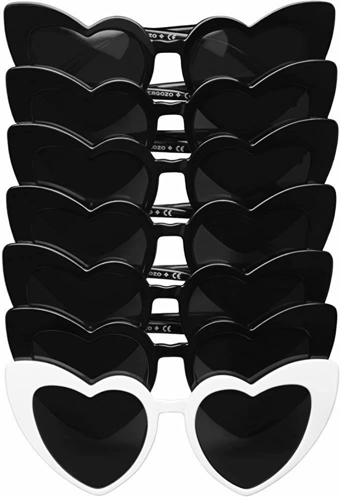 black and white heart shaped sunglasses are stacked on top of each other