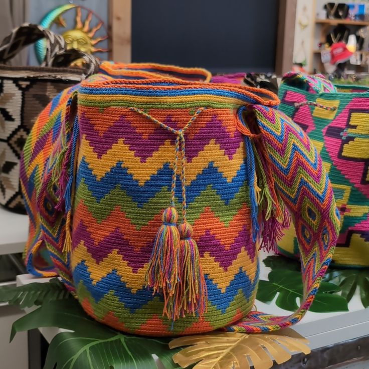 One Of A Kind Indigenous Colombian Mochila. When The Wayu Tribe Makes These Handbags They Set The Intention To Put Something Unique Into The Universe. Their Creations Are All "One Of Kind" Items. We Have Been Collecting Them For Over 8 Years And Have Never Seen Two Exactly Alike. So You Are Purchasing A Truly One Of A Kind Item. Which Makes For A Very Unique Gift For Yourself Or Your Loved Ones. Multicolor Bucket Bag With Adjustable Strap, Multicolor Shoulder Bucket Bag With Adjustable Strap, Multicolor Shoulder Bucket Bag For Travel, Multicolor Bucket Crochet Bag For Festivals, Multicolor Crochet Bucket Bag For Festivals, Multicolor Bucket Bag With Removable Pouch, Multicolor Bucket Shoulder Bag With Adjustable Strap, Multicolor Handwoven Pouch Bag, Multicolor Travel Bucket Shoulder Bag