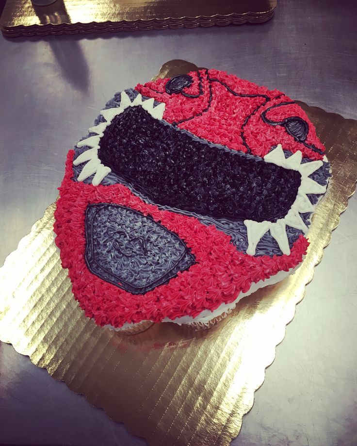 a red and black cake on top of a table