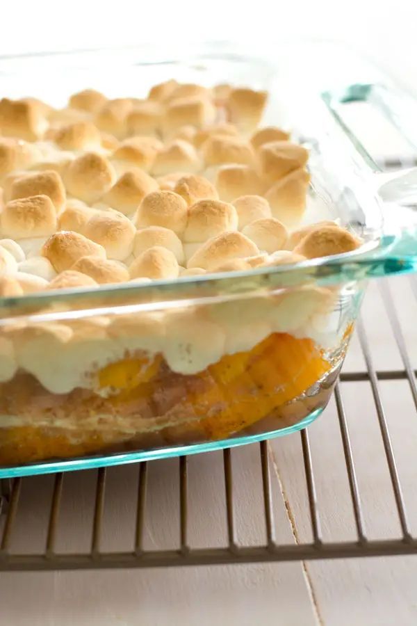 a casserole dish is sitting on a cooling rack, ready to be eaten